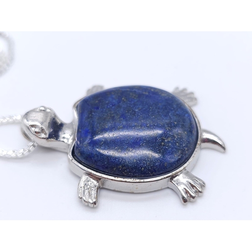 1720 - A Lapis Lazuli Turtle Pendant on a White Metal Necklace. 4cm and 46cm.