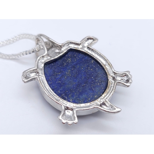 1720 - A Lapis Lazuli Turtle Pendant on a White Metal Necklace. 4cm and 46cm.