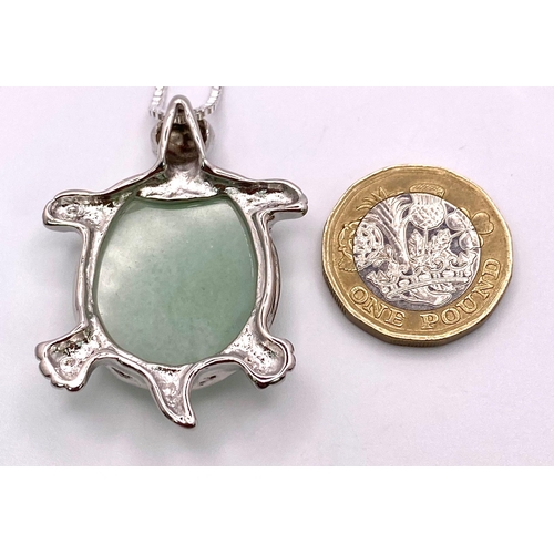 1749 - A Green Jade Turtle Pendant on a White Metal Necklace. 4cm and 44cm.