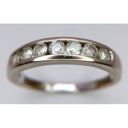 310 - A 9K WHITE GOLD RING WITH 7 CHANNEL SET DIAMONDS .  2.8gms    size S