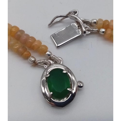 655 - A Two-Row Small Rondelle Opal Gemstone Necklace with Emerald clasp and 925 Silver Clasp. 42-46cm. 26... 