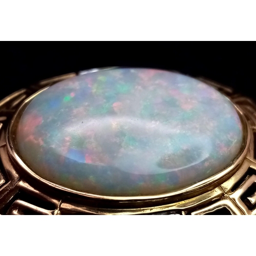 749 - A 14k Yellow Gold and Opal Pendant, featuring two small diamonds on each side, Opal dimensions: 20mm... 