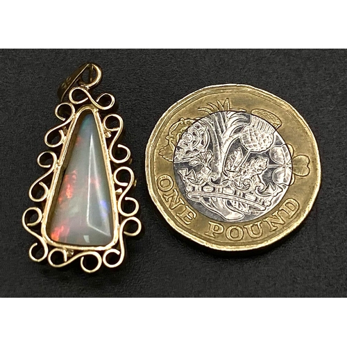 814 - A 9K Yellow Gold Triangular Opal and Pendant. Good colour-play. 3.5cm. 3.27g weight.