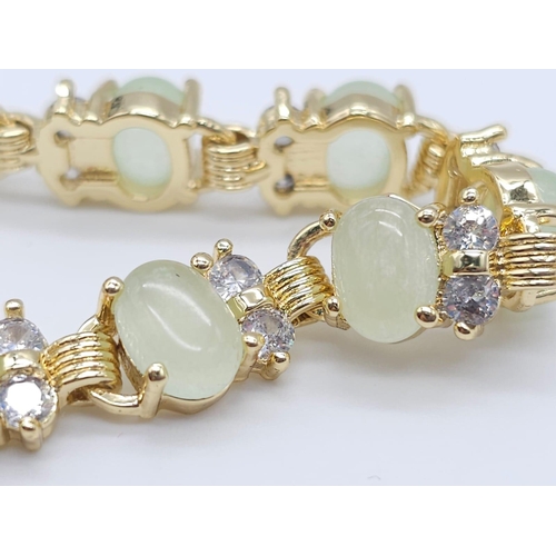 828 - An Apple Green Jade and White Stone Tennis Bracelet in Gilded Metal. 19cm.