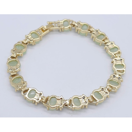 828 - An Apple Green Jade and White Stone Tennis Bracelet in Gilded Metal. 19cm.