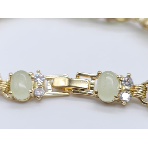 828 - An Apple Green Jade and White Stone Tennis Bracelet in Gilded Metal. 19cm.