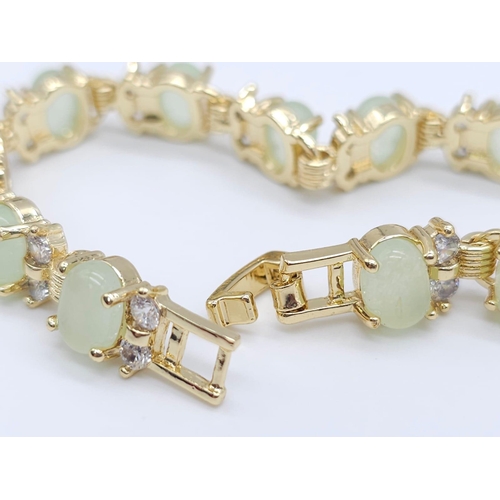 828 - An Apple Green Jade and White Stone Tennis Bracelet in Gilded Metal. 19cm.