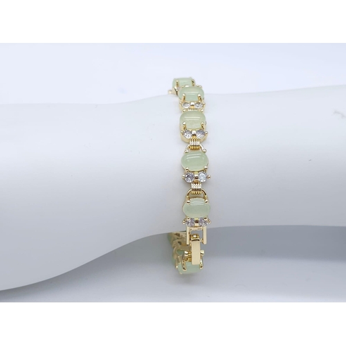 828 - An Apple Green Jade and White Stone Tennis Bracelet in Gilded Metal. 19cm.