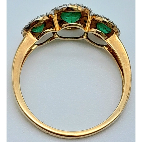 988 - A 9K YELLOW GOLD DIMAOND & EMERALD TRIPLE CLUSTER RING. 2G. SIZE M