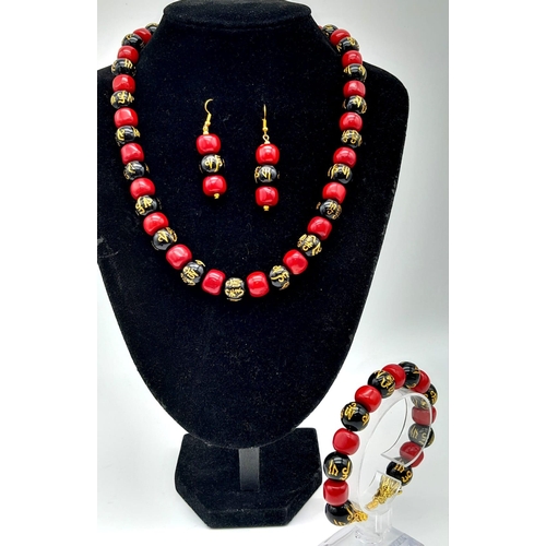 1220 - An original “GOOD LUCK” necklace, bracelet and earrings set with natural red coral alternating with ... 