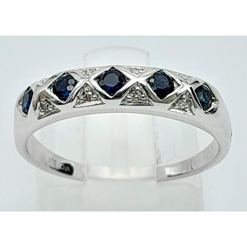 1347 - A 9K WHITE GOLD DIAMOND & SAPPHIRE BAND RING. 2.2G SIZE M.