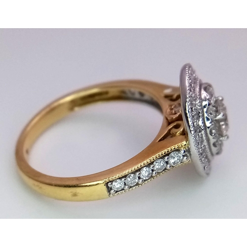 10 - An 18 k yellow gold ring with a cluster of diamonds and more diamonds on the shoulders. Diamond tota... 