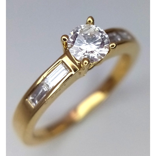 138 - A 18CT YELLOW GOLD DIAMOND SOLITAIRE RING WITH DIAMOND BAGUETTE ON BOTH SHOULDERS 0.57CT 3.8G SIZE M... 