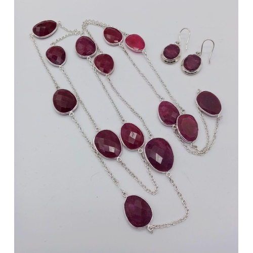 1716 - A Long Faceted Ruby Chain Link Necklace and Earring Set.
106cm necklace length. 2cm earring drop. Se... 