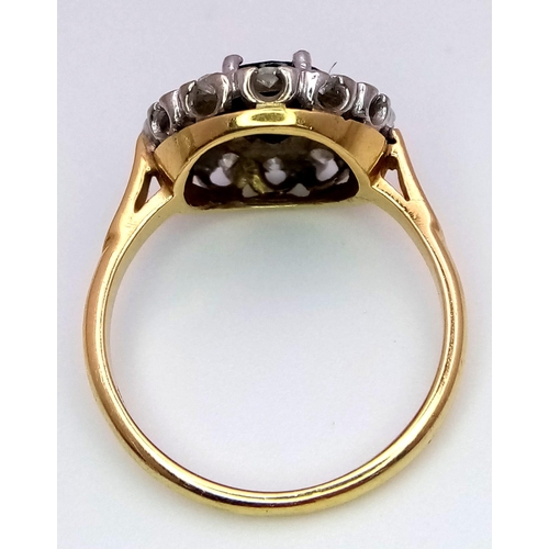 24 - An 18 K yellow gold ring with a round cut sapphire (1.25 carats) surrounded by a halo of diamonds. S... 