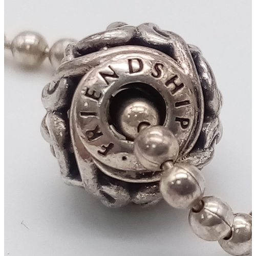 451 - A sterling silver PANDORA friendship bracelet with two beads/charms. Weight: 6.8 g.