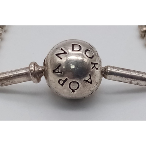 451 - A sterling silver PANDORA friendship bracelet with two beads/charms. Weight: 6.8 g.