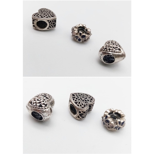 465 - A trio of sterling silver PANDORA charms. One is heart shaped, one is heart shaped with the writing:... 