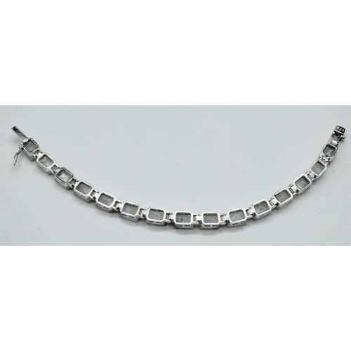 531 - A Rectangular Cut Moonstone Gemstone Tennis Bracelet set in 925 Silver. 19cm. 17.8g total weight. Re... 