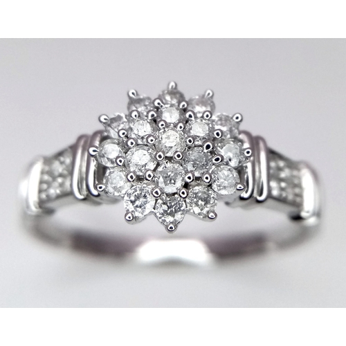 581 - 9K White gold Diamond Set Cluster Ring with Diamond Shoulders.  2.6g.  Size T1/2. (dia 0.50ct). Ref:... 