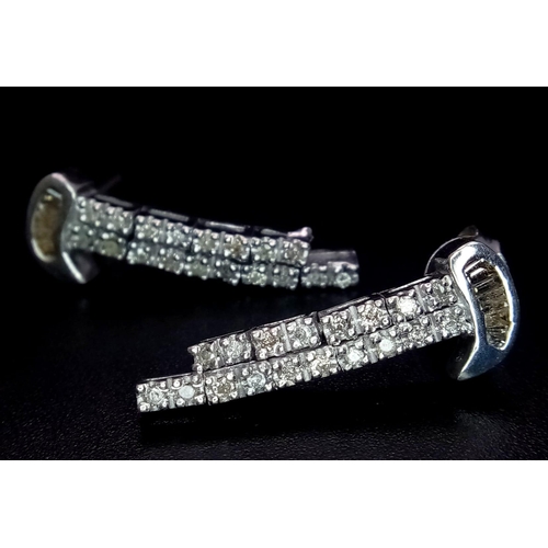 62 - A Pair of 18K White God Diamond Drop Earrings. 26mm length, 0.50ctw, 6.1g total weight.