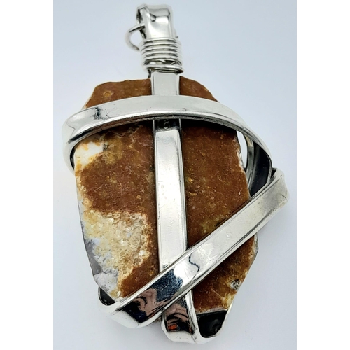 658 - A Sterling Silver and Natural Rough Stone Set Pendant. 6.5cm length, 44g total weight.