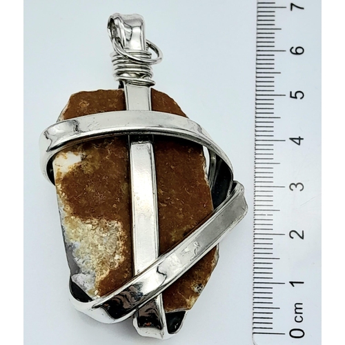 658 - A Sterling Silver and Natural Rough Stone Set Pendant. 6.5cm length, 44g total weight.