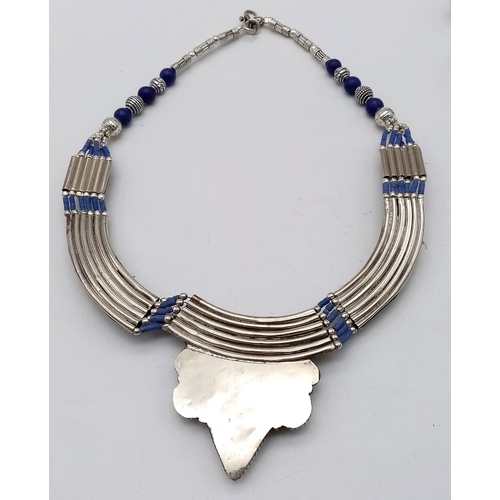 765 - A Lapis Lazuli Jewellery Suite. To include: Egyptian style choker necklace - 38cm. Decorative oval b... 