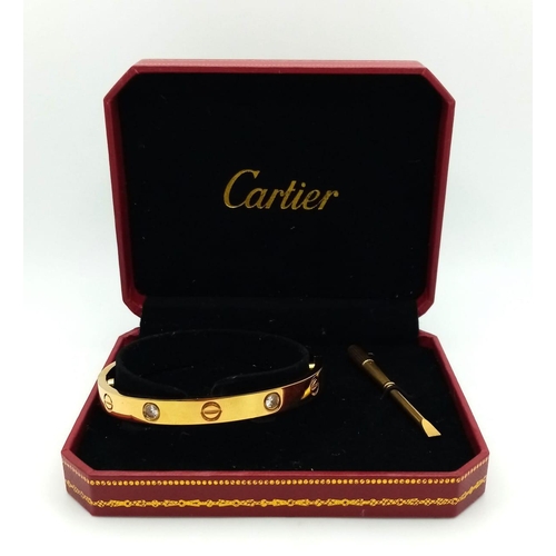 809 - A CARTIER STYLE GOLD TONE BANGLE AND SCREWDRIVER IN RED BOX 
ref: H 5004