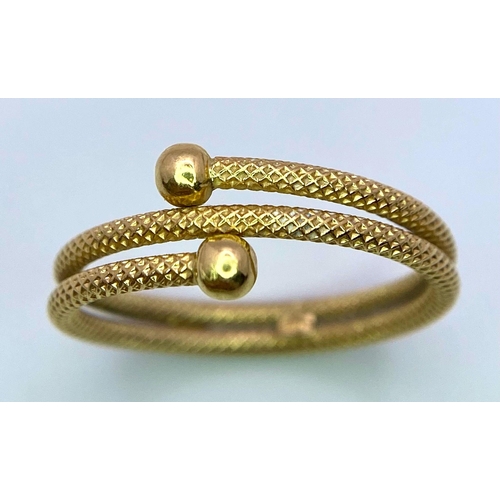 401 - An 18 K yellow gold ring with a twisted, snake like design. Size: O, weight: 1.9 g.