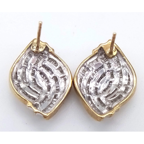 609 - A Pair of 9K Yellow Gold Diamond Swirl Earrings. Baguette diamonds - 2.5ct approx. Boxed. Ref:6942