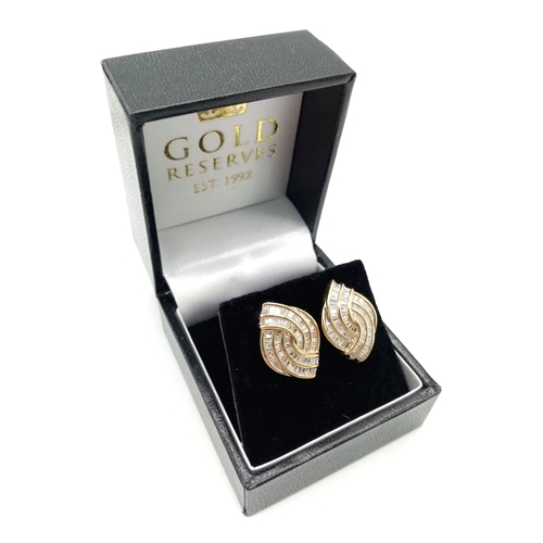 609 - A Pair of 9K Yellow Gold Diamond Swirl Earrings. Baguette diamonds - 2.5ct approx. Boxed. Ref:6942