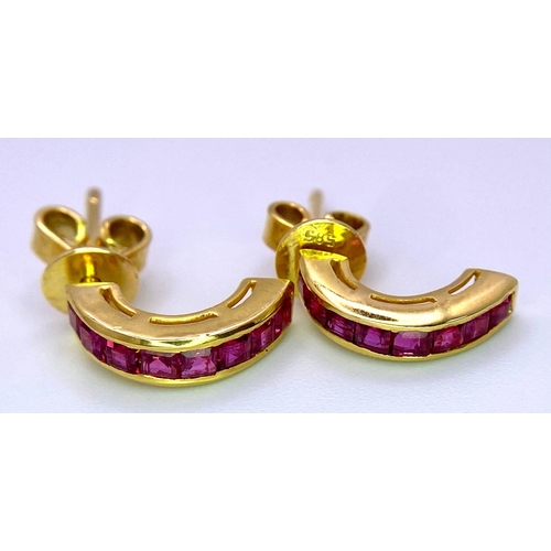 453 - A 14 K yellow gold pair of ruby set earrings. weight: 2.3 g