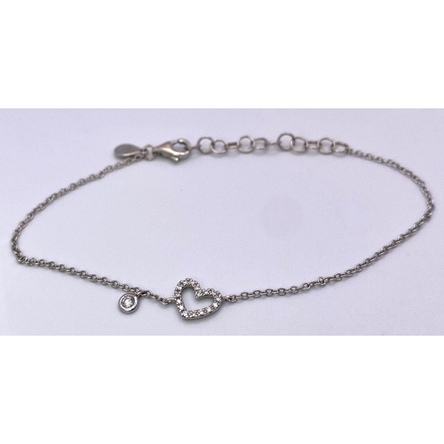 467 - An 18 K white gold MONICA VINEDAR chain bracelet with a diamond set heart and a diamond charm.  Weig... 