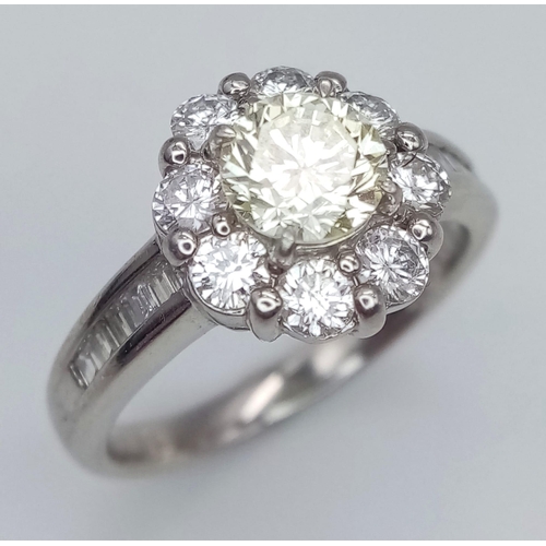 484 - AN EXQUISITE PLATINUM RING WITH A CENTRE PALE YELLOW DIAMOND SURRONDED BY HIGH QUALITY DIAMONDS SET ... 