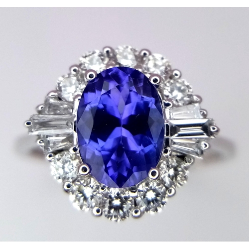 666 - An 18K White Gold Oval Tanzanite and Diamond Cluster Ring. Tanzanite - 1.54ct. Diamonds - 0.57ctw. S... 