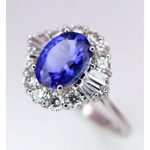 666 - An 18K White Gold Oval Tanzanite and Diamond Cluster Ring. Tanzanite - 1.54ct. Diamonds - 0.57ctw. S... 