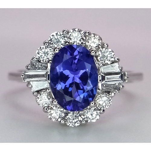 666 - An 18K White Gold Oval Tanzanite and Diamond Cluster Ring. Tanzanite - 1.54ct. Diamonds - 0.57ctw. S... 