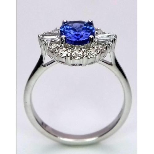 666 - An 18K White Gold Oval Tanzanite and Diamond Cluster Ring. Tanzanite - 1.54ct. Diamonds - 0.57ctw. S... 