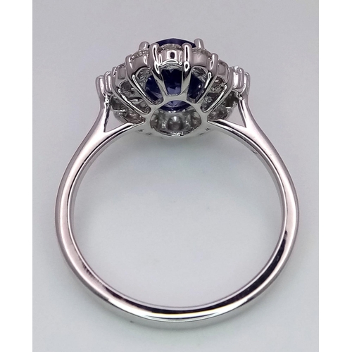 666 - An 18K White Gold Oval Tanzanite and Diamond Cluster Ring. Tanzanite - 1.54ct. Diamonds - 0.57ctw. S... 