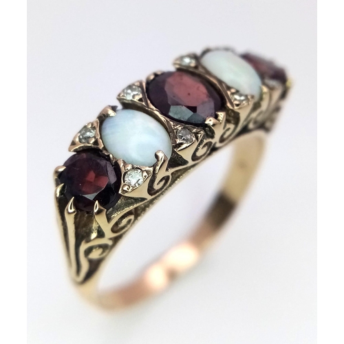 588 - A Hand-Made Victorian Yellow Gold Garnet and Opal Five Stone Ring. Scroll pattern sides. Size U. 5.3... 