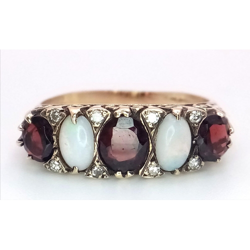 588 - A Hand-Made Victorian Yellow Gold Garnet and Opal Five Stone Ring. Scroll pattern sides. Size U. 5.3... 