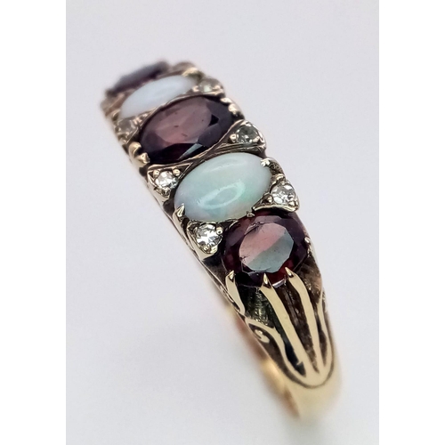 588 - A Hand-Made Victorian Yellow Gold Garnet and Opal Five Stone Ring. Scroll pattern sides. Size U. 5.3... 