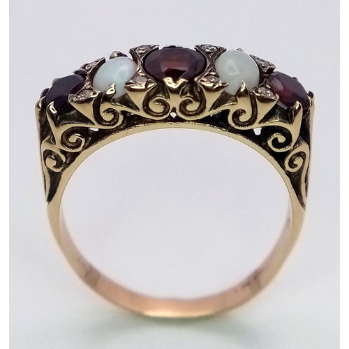 588 - A Hand-Made Victorian Yellow Gold Garnet and Opal Five Stone Ring. Scroll pattern sides. Size U. 5.3... 