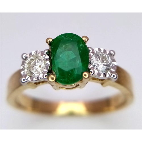 804 - A 9K Yellow Gold Ring set with an Oval 0.50ct Emerald and Flanked by 2 Diamonds - 0.20ct. Emerald ch... 