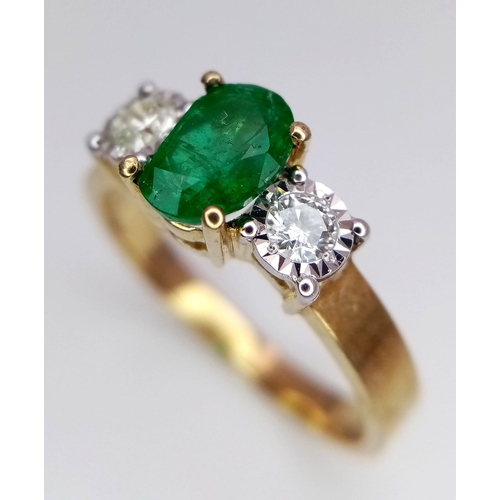 804 - A 9K Yellow Gold Ring set with an Oval 0.50ct Emerald and Flanked by 2 Diamonds - 0.20ct. Emerald ch... 