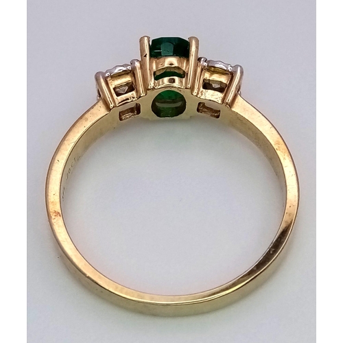 804 - A 9K Yellow Gold Ring set with an Oval 0.50ct Emerald and Flanked by 2 Diamonds - 0.20ct. Emerald ch... 