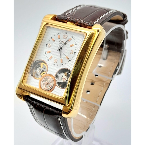 1196 - A Men’s Gold Tone, Skeleton Design, Tank Style Watch by Cjiaba. 
36mm Case Width. Full working order... 