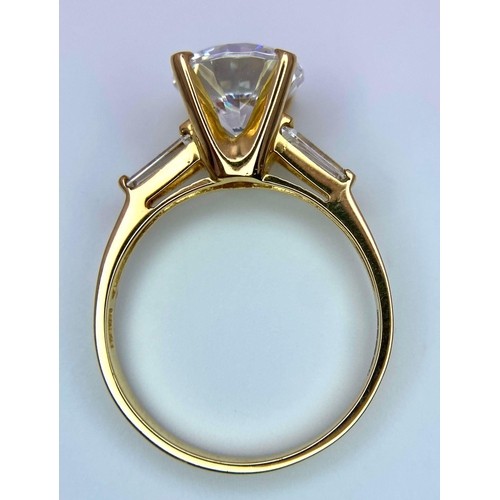 135 - A VERY IMPRESSIVE 14K GOLD RING WITH A 3ct ZIRCONIA STONE AND BAGUETTES SHOULDERS .     4.5gms   siz... 