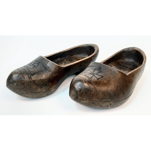 782 - Pair of Dutch clogs that have been crudely engraved by a German soldier to mark the successful invas... 